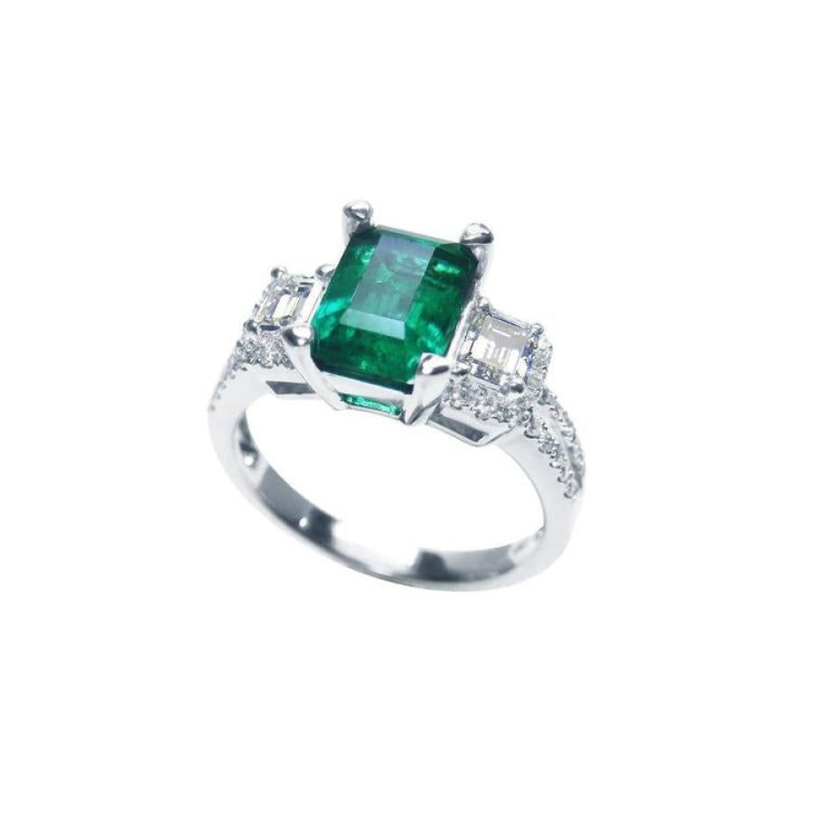 1.88 carat emerald ring with side emerald-cut and round diamonds in 18k white gold.