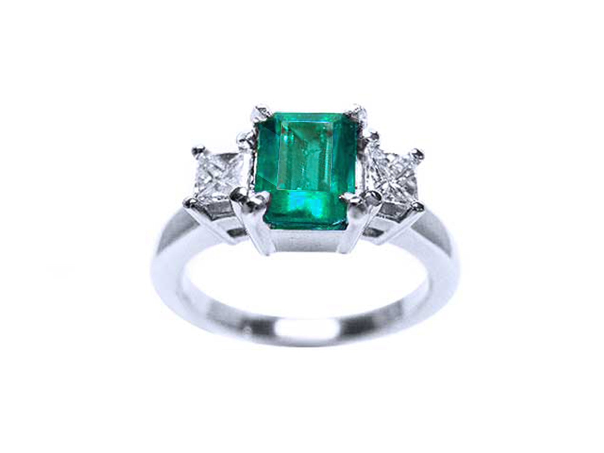 A white gold ring with emerald and side diamonds on a white background