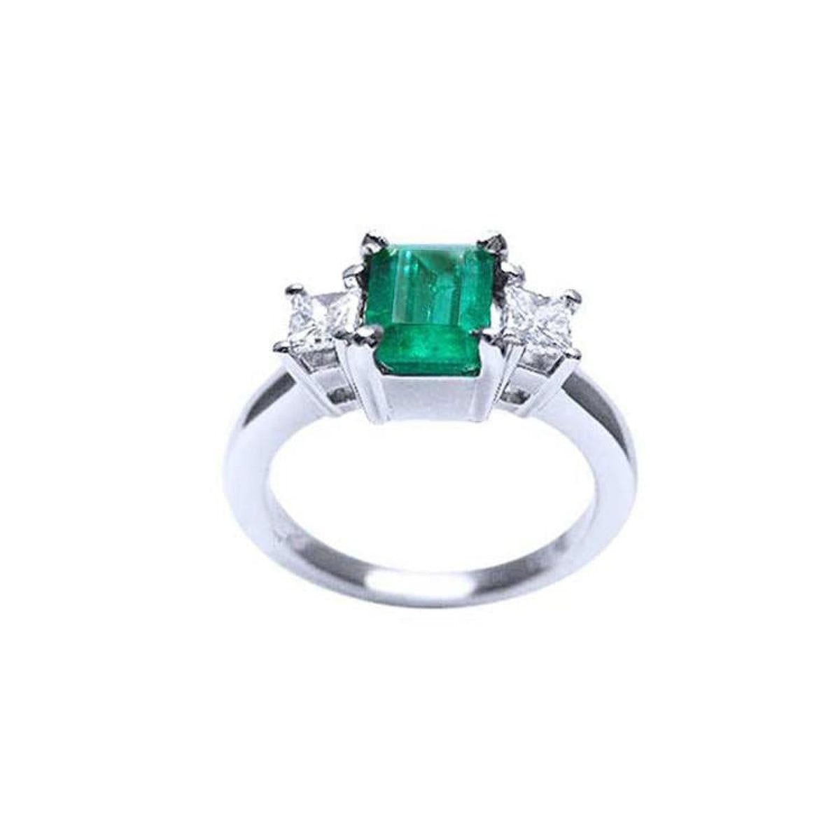 18k white gold three stone ring with a vibrant emerald and two princess cut diamonds.