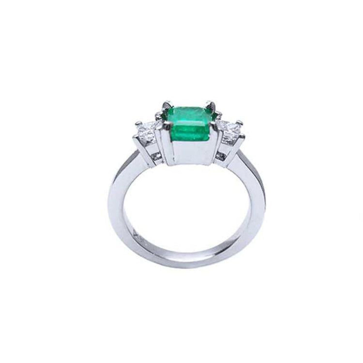 18k white gold three-stone ring with a 1.38 ct emerald and two princess-cut side diamonds.