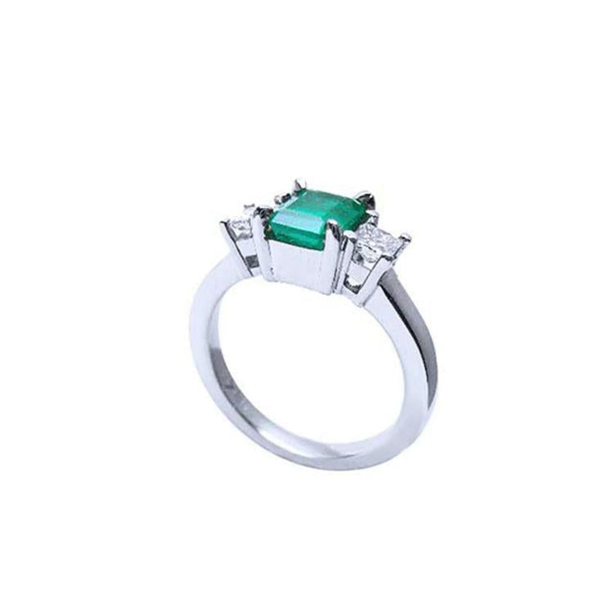 18k white gold three-stone ring with a rectangular emerald and two princess-cut side diamonds.