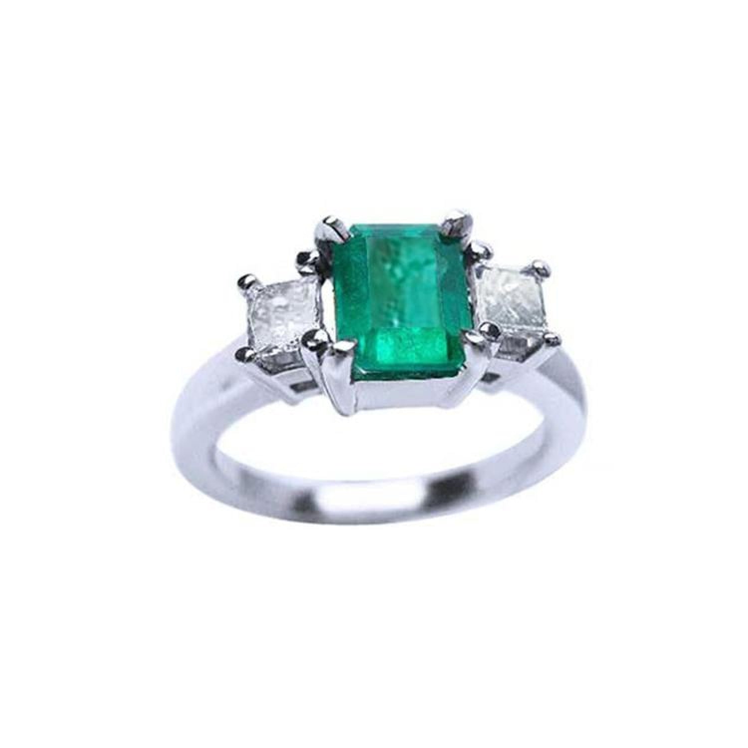 18k white gold three-stone ring with a rectangular emerald and two princess-cut side diamonds.