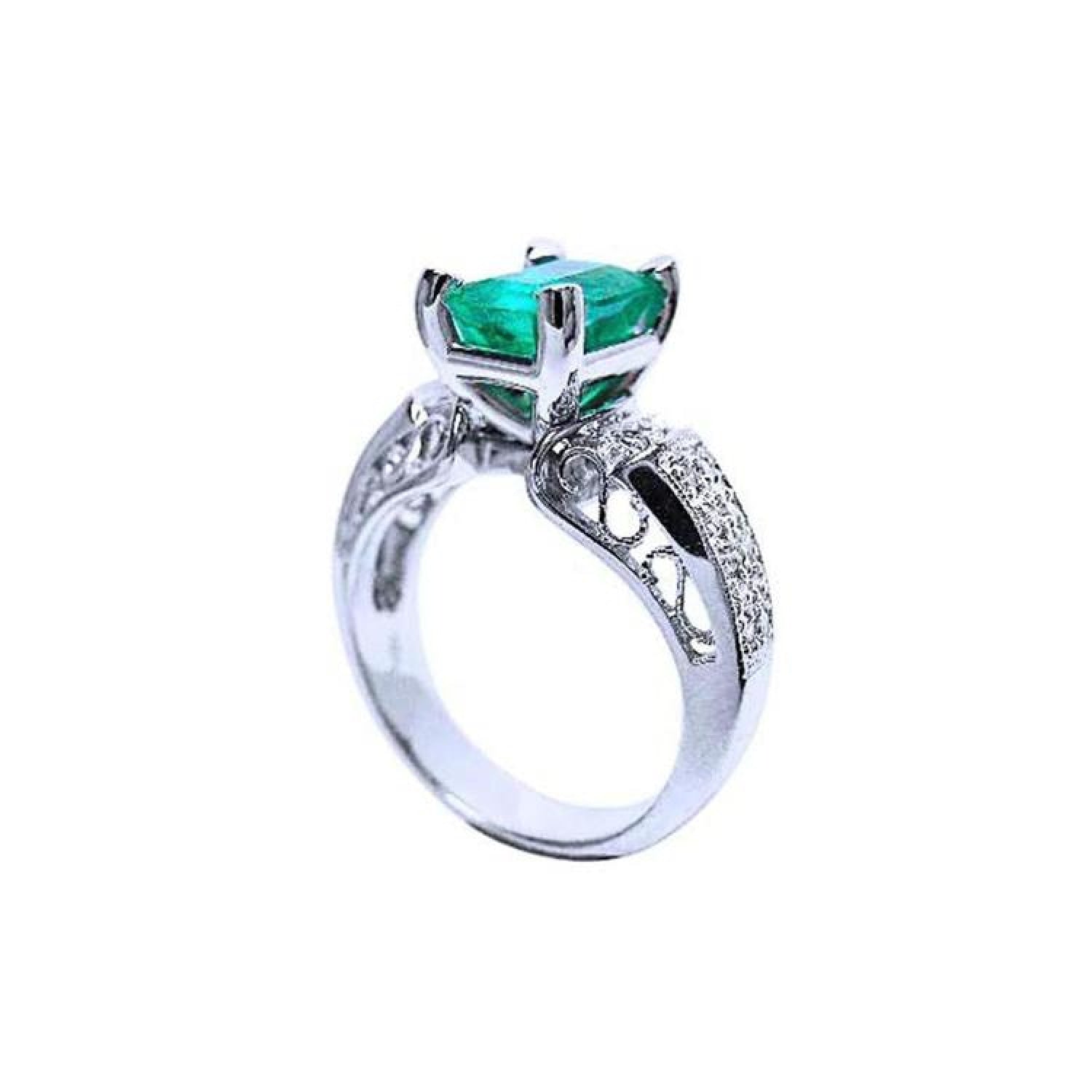 Emerald-cut Colombian emerald ring in 18K white gold with diamond-studded band.
