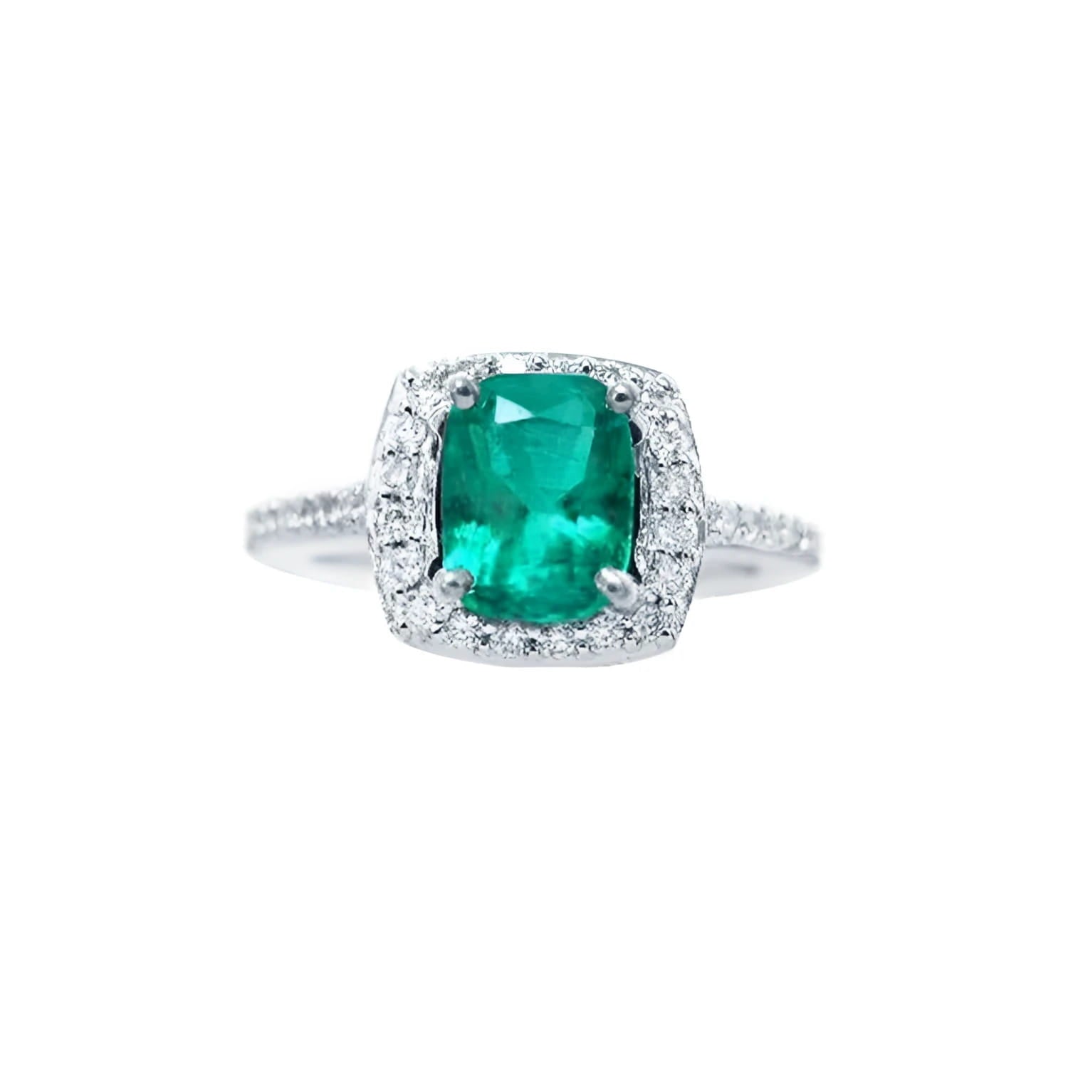 Cushion cut emerald ring with diamond halo and band in 14K white gold.