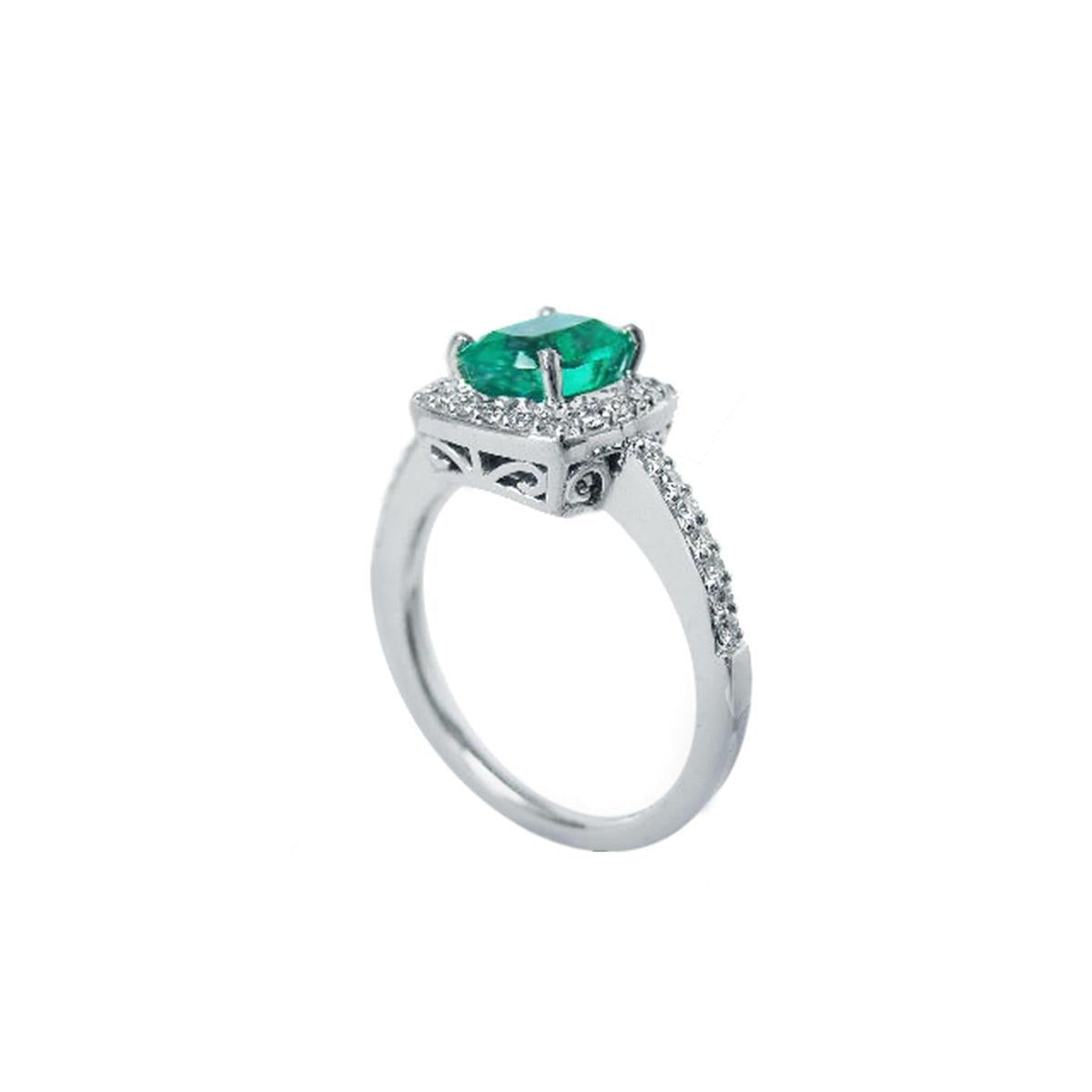 A 14k white gold cushion emerald ring on a half side profile view.