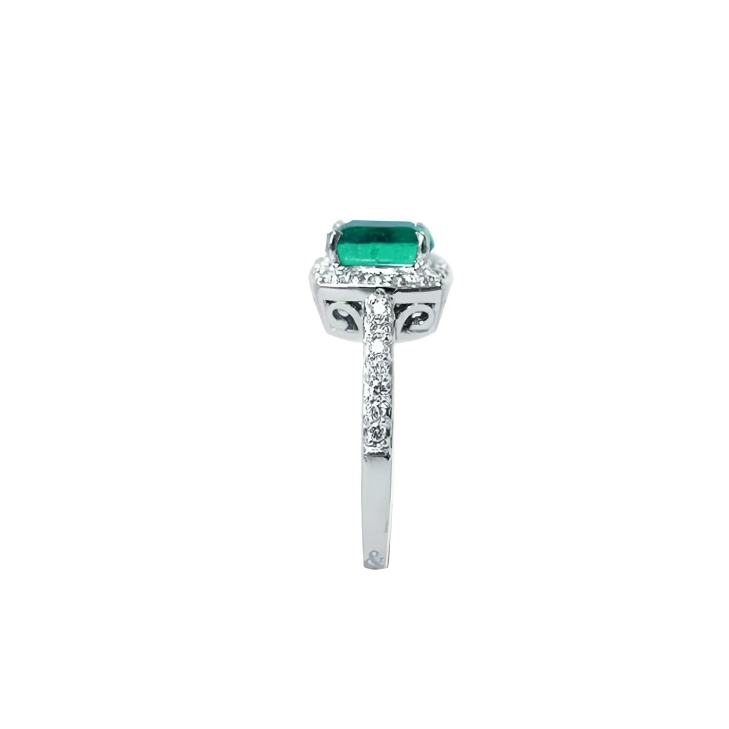 Cushion cut emerald ring with diamond halo and pavé band in 14K white gold.
