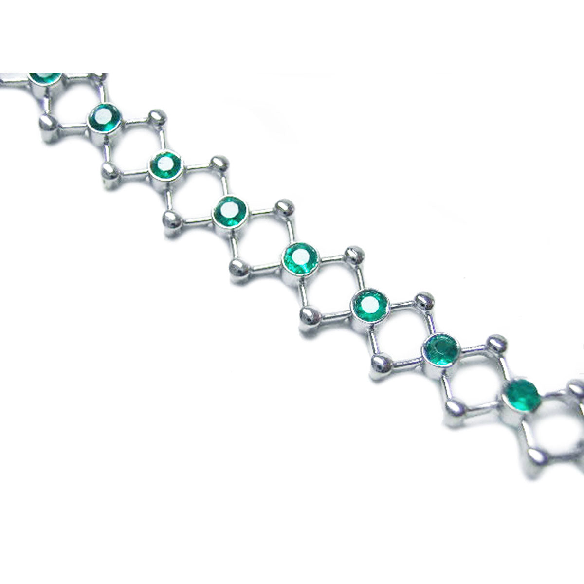 A white gold bracelet with round cut natural emeralds on a white background.