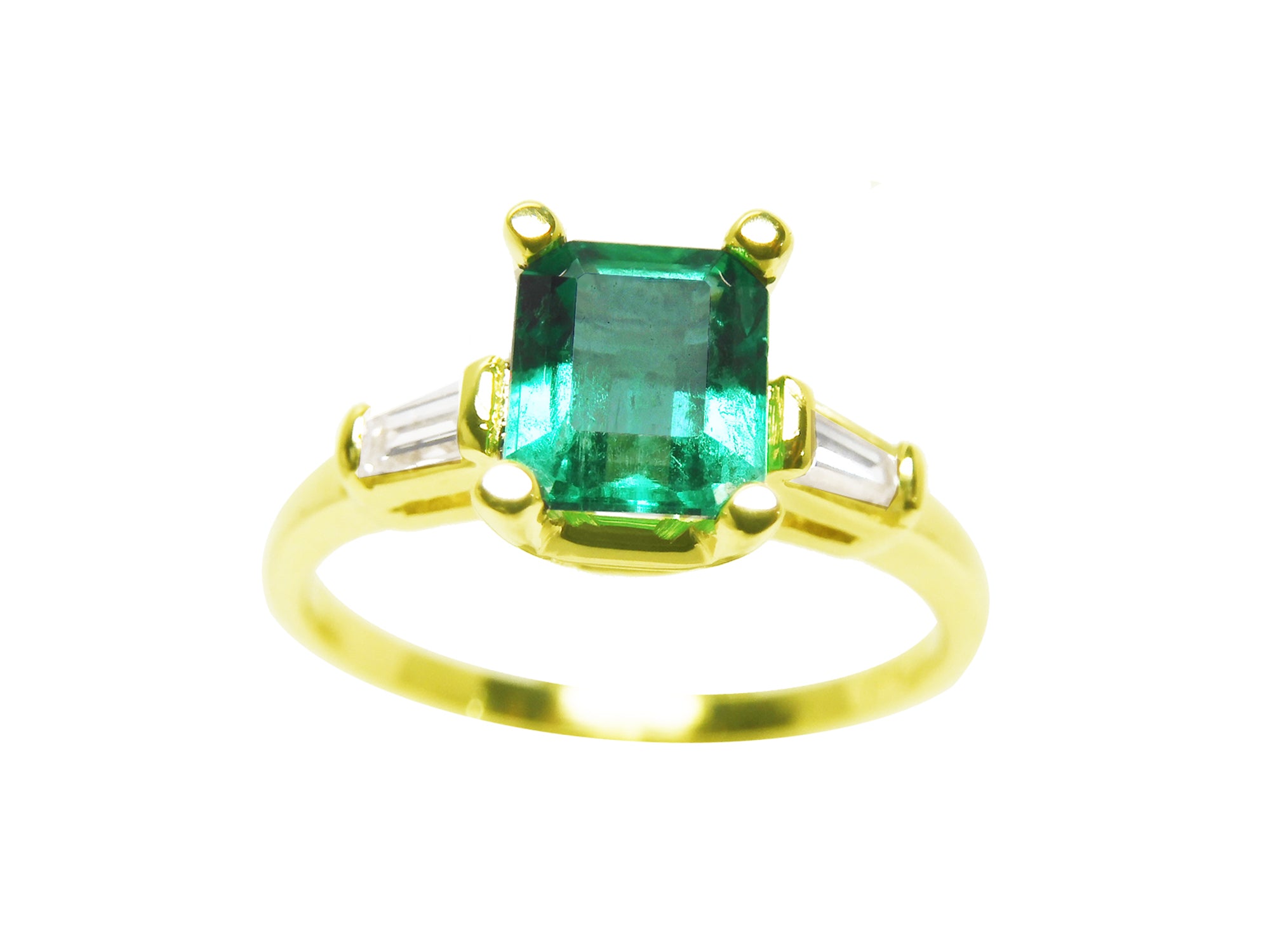 Topside view of a emerald-cut with side baguettes diamond ring in yellow gold.