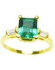 Topside view of a emerald-cut with side baguettes diamond ring in yellow gold.