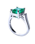 Showcasing the top emerald setting, gallery, and band of a Colombian emerald ring.