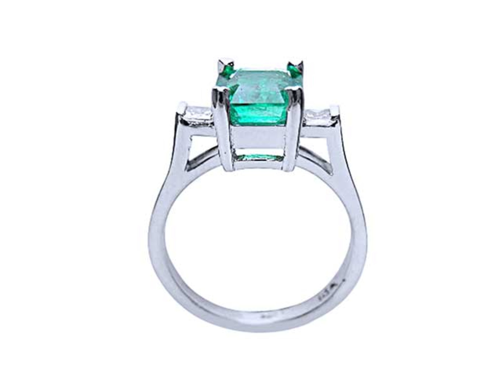 A detailed view of an emerald and princess-cut diamond ring, highlighting the top, side gallery, and band.