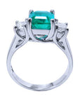 A natural emerald and diamond side princess cut ring on a lateral position, top and gallery profile view.