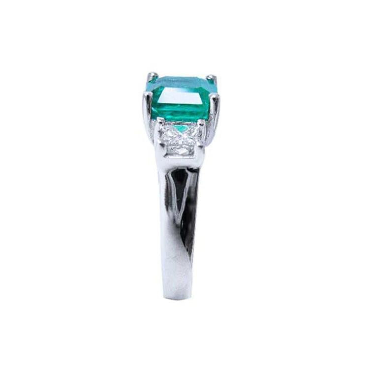 1.62 carat emerald engagement ring in 14k white gold with side princess cut diamonds.