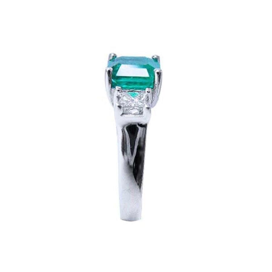 1.62 carat emerald engagement ring in 14k white gold with side princess cut diamonds.