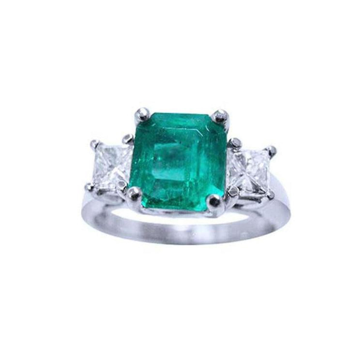 Natural colombian emerald and side princess cut diamonds three stone ring in 14k white gold.
