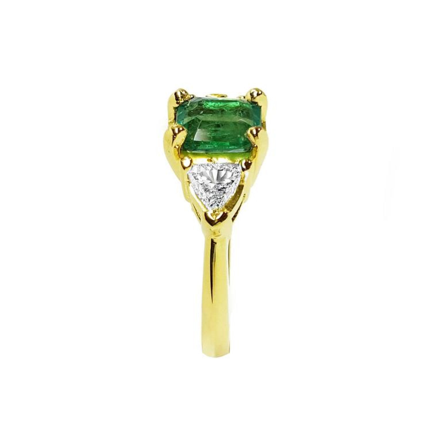 1.51 ct. emerald and trillion-cut diamonds ring in 18k yellow gold.