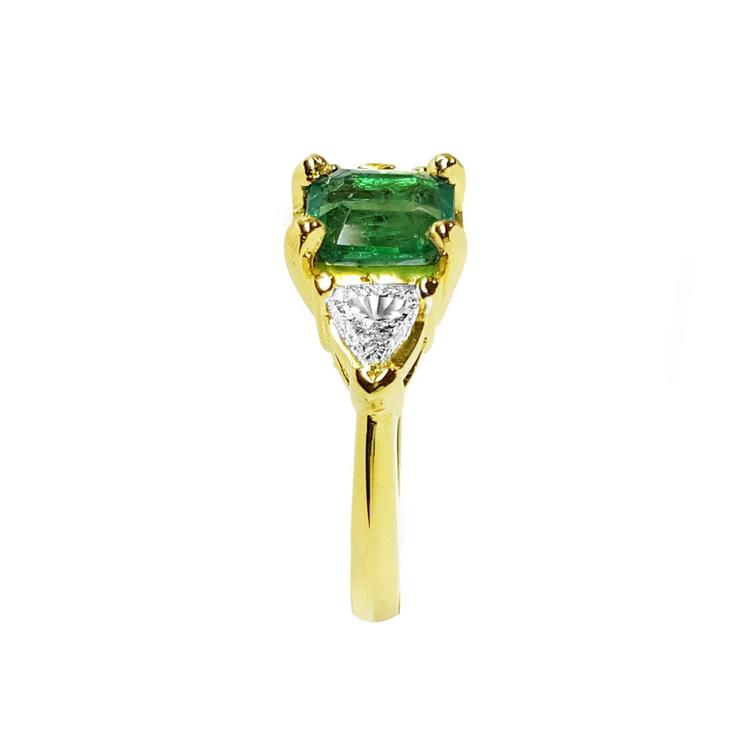 1.51 ct. emerald and trillion-cut diamonds ring in 18k yellow gold.
