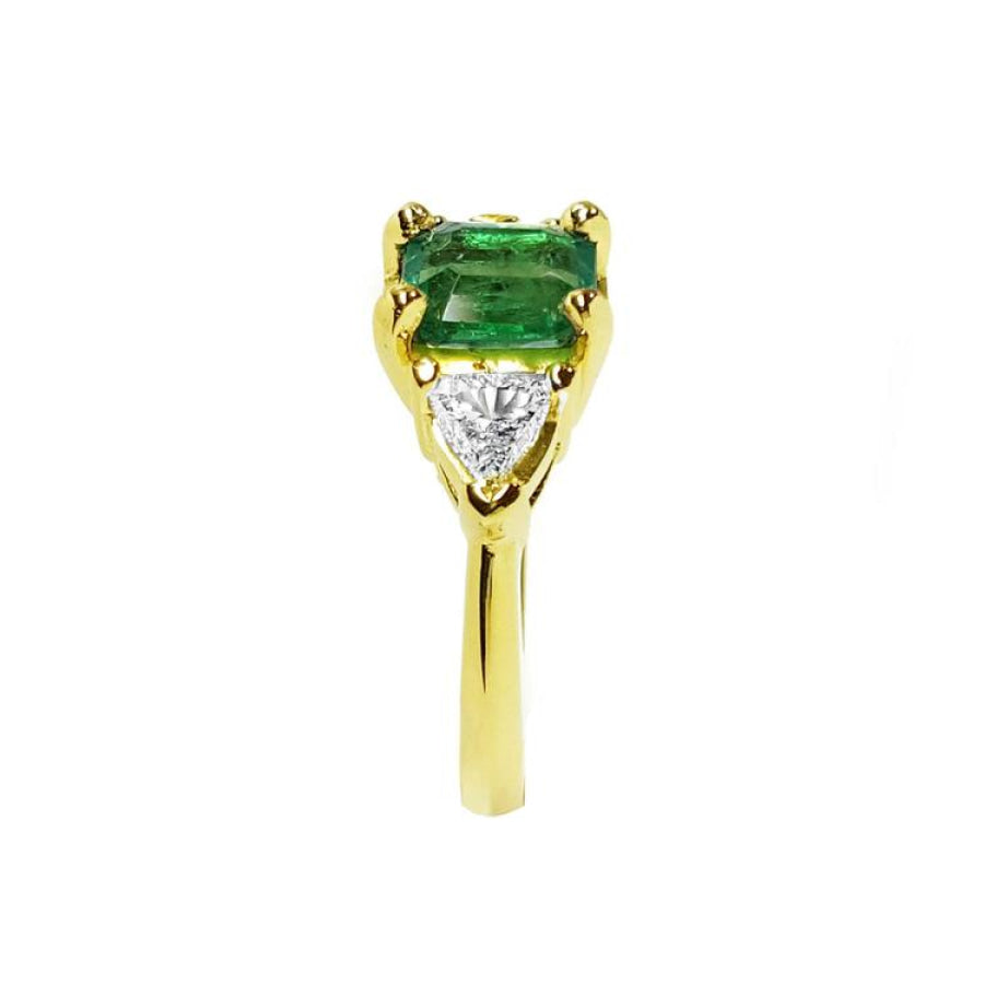 1.51 ct. emerald and trillion-cut diamonds ring in 18k yellow gold.