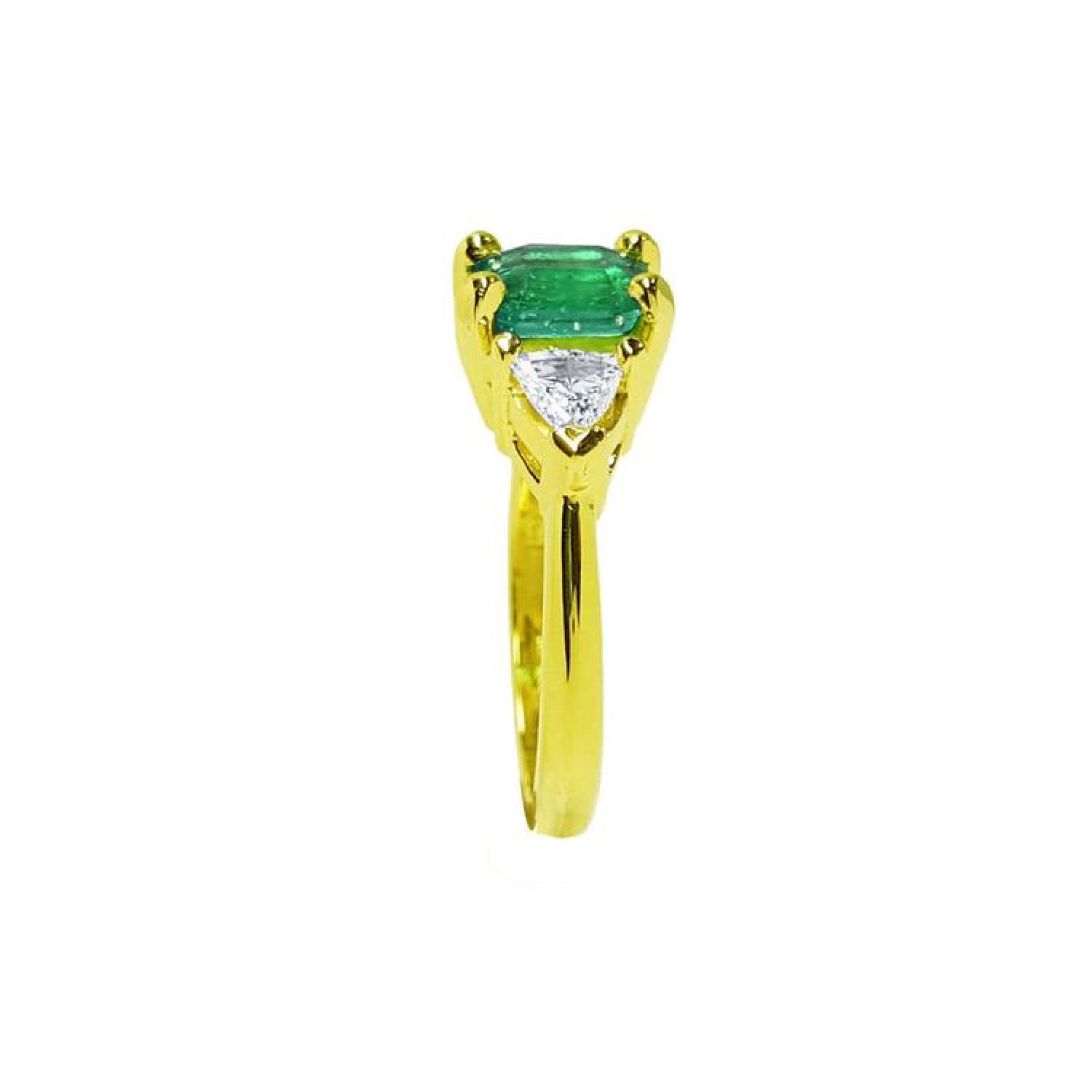 1.51 ct. emerald and trillion cut diamonds ring in 18k yellow gold.