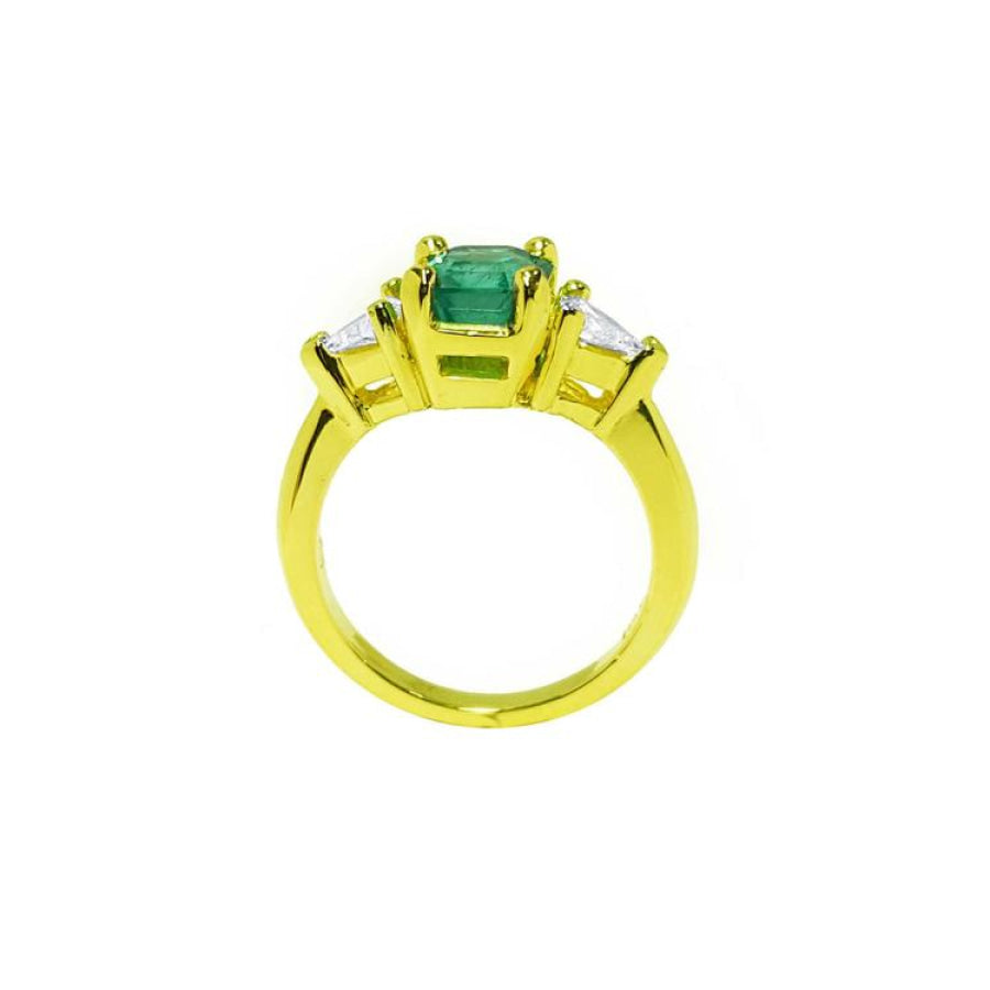 18k gold ring with a 1.51 ct. emerald and two trillion-cut side diamonds.