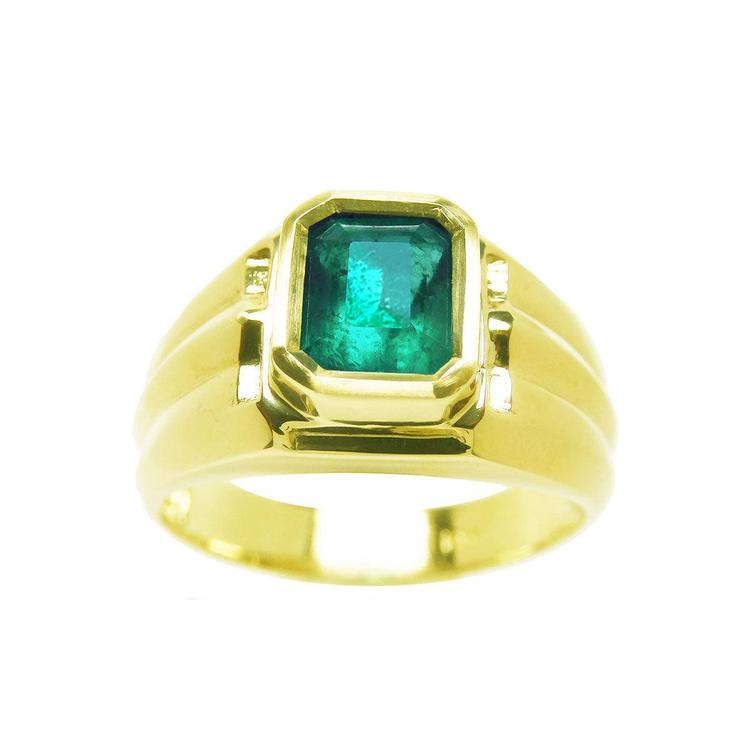 A perspective of a men's natural colombian emerald solitaire gold ring on topside view.