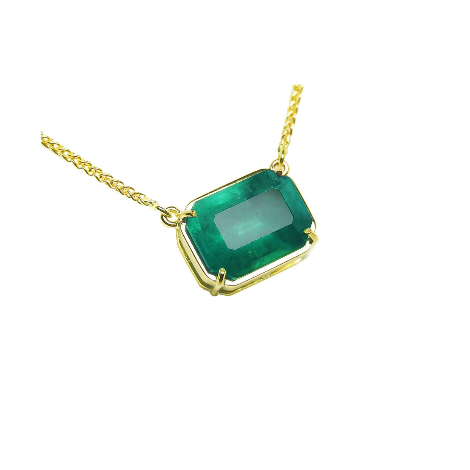 5.52 carat emerald-cut Colombian emerald solitaire necklace in 18K yellow gold.
