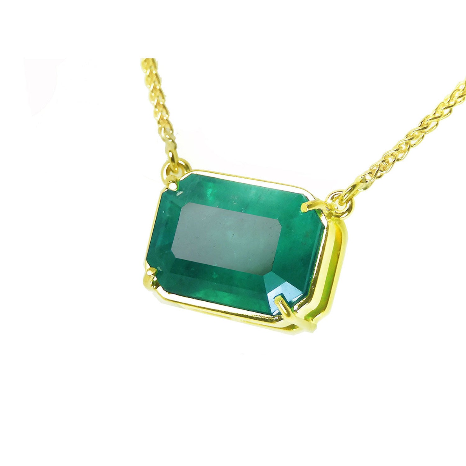 5.52 carat emerald-cut Colombian emerald solitaire necklace in 18K yellow gold.