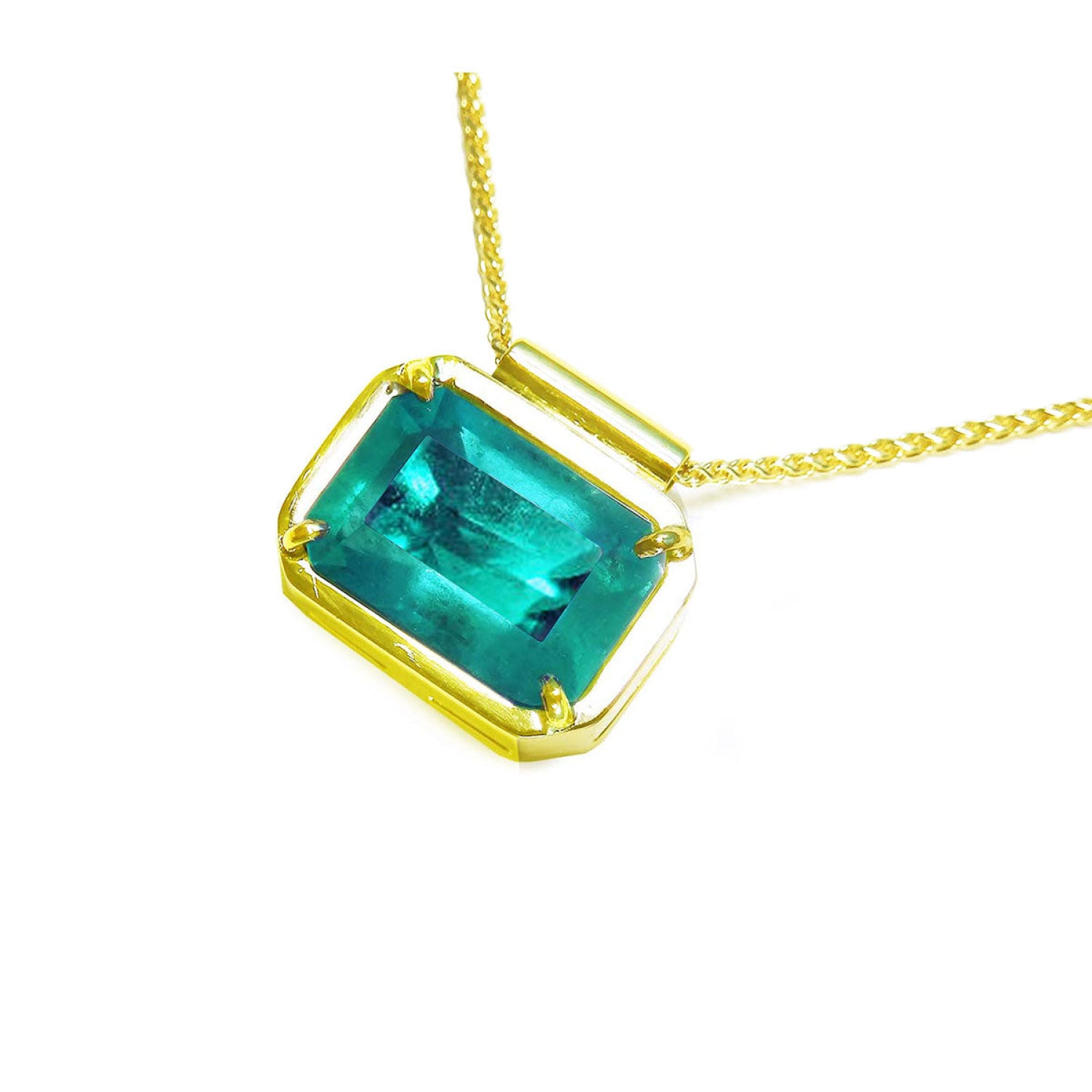 Natural Muzo Colombian emerald solitaire in 18K yellow gold, east-west orientation.