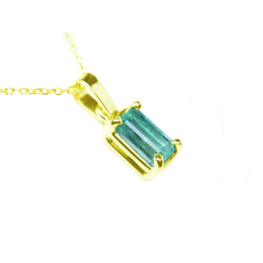 A 14k yellow gold solitaire pendant featuring a Muzo-born natural Colombian emerald in a prong setting.