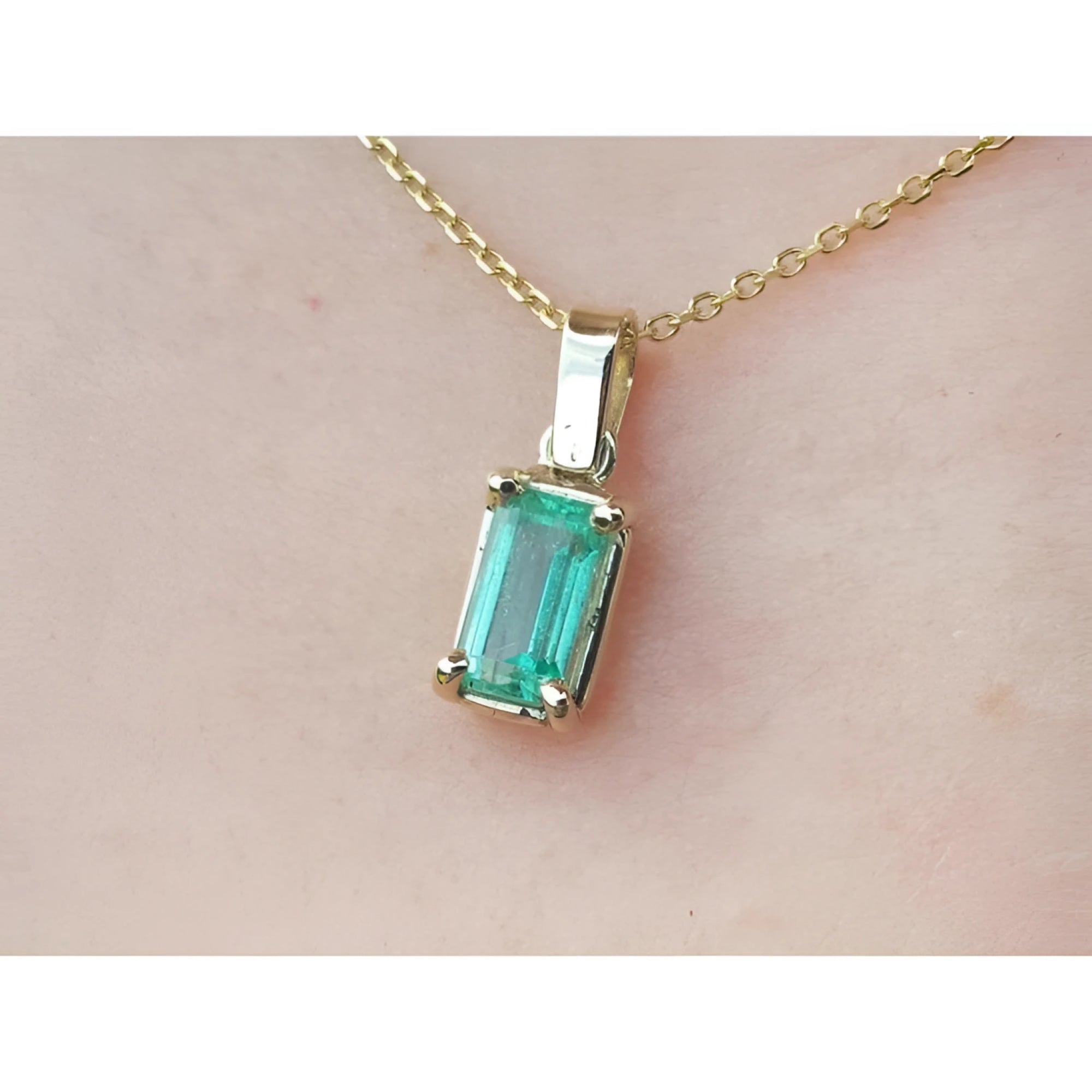 1.31 ct emerald solitaire pendant in 14K yellow gold, featuring a vibrant green emerald.