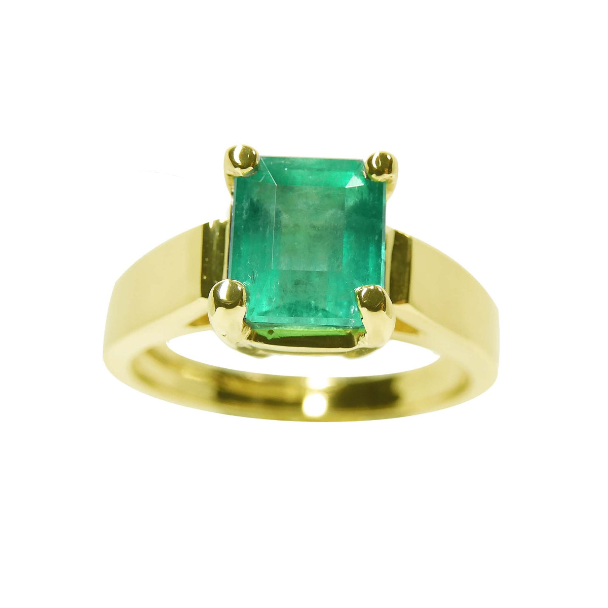 A rectangular emerald-cut natural colombian emerald solitaire ring in 14k gold.