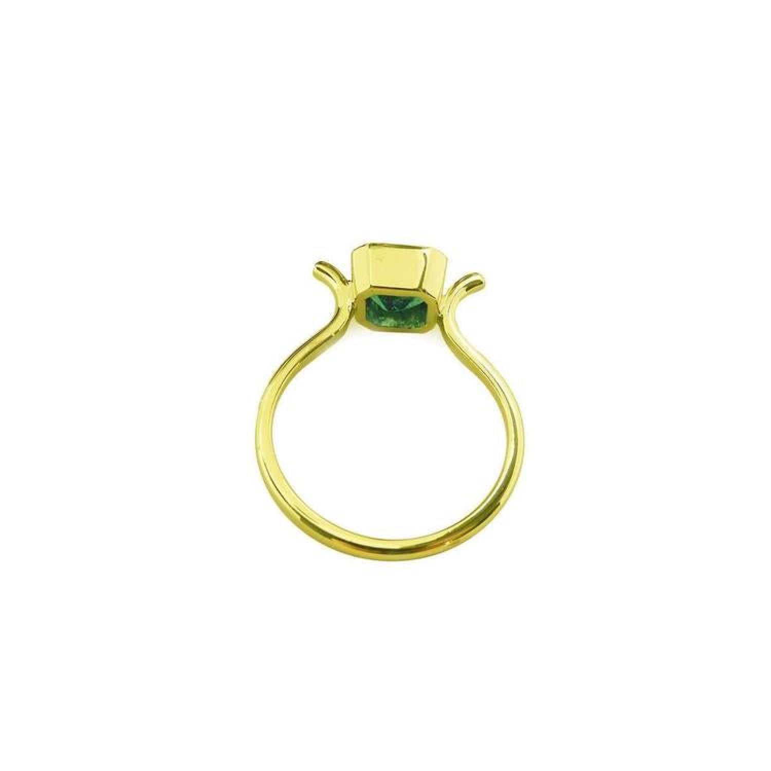 0.81 ct. emerald solitaire ring in 14K yellow gold with a bezel setting.