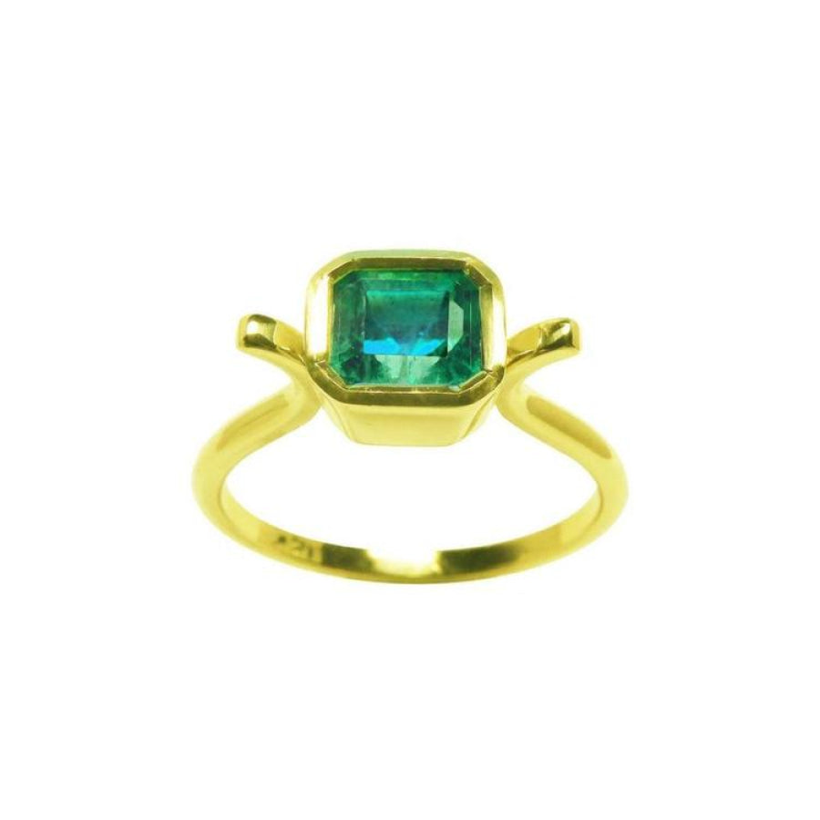 A solitaire natural colombian emerald ring bezel set in 14k yellow gold.
