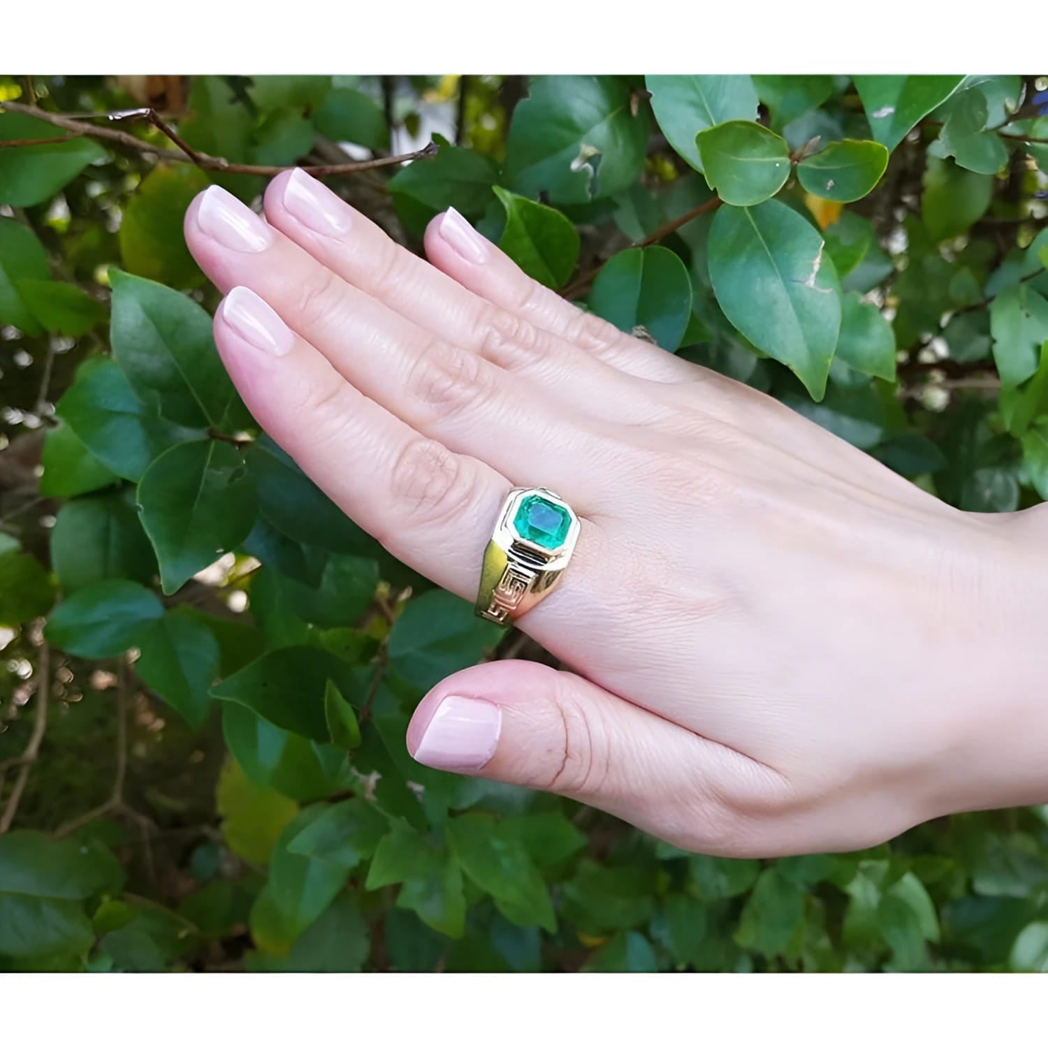 Men's 14K gold solitaire ring with a bezel-set Colombian emerald and Greek Key design.