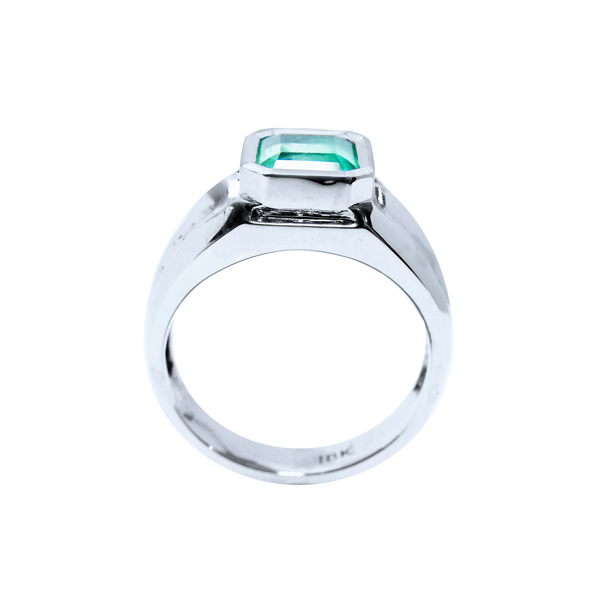 A lateral view of a white gold mens emerald ring displaying its top setting and band design.