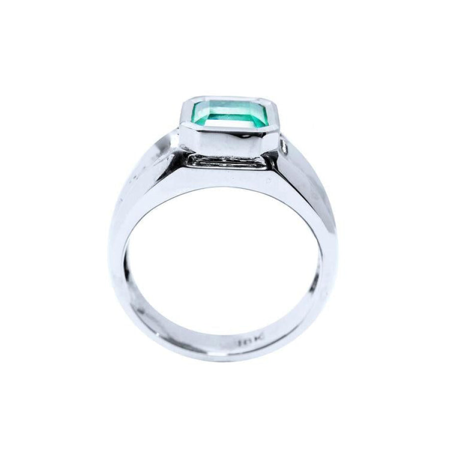 Men's 18K white gold solitaire ring with a bezel-set, rectangular Muzo emerald.