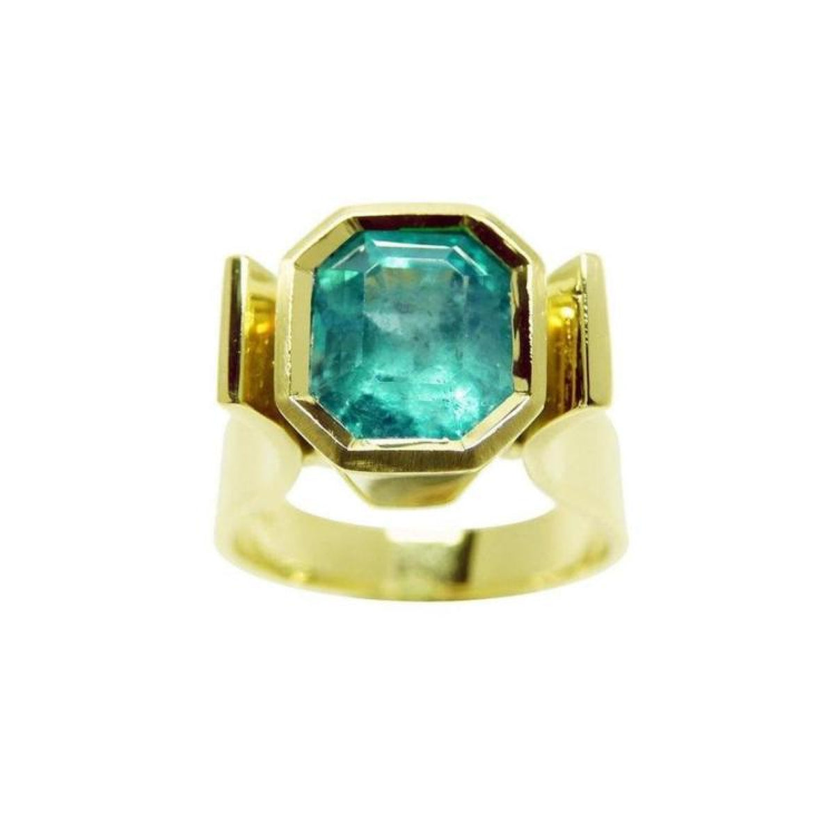 Colombian emerald solitaire ring for women bezel set in 14k yellow gold.