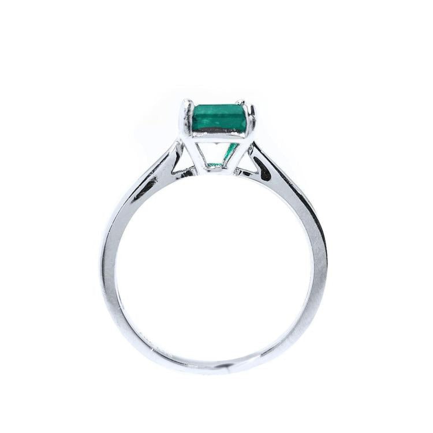 Colombian emerald solitaire silver ring with a square emerald cut gemstone in a four-prong setting.