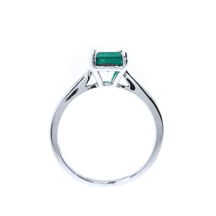 Colombian emerald solitaire silver ring with a square emerald cut gemstone in a four-prong setting.