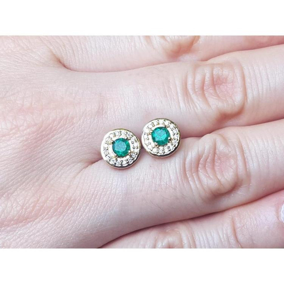 14k yellow gold emerald halo diamond stud earrings with deep bluish-green round cut emeralds.