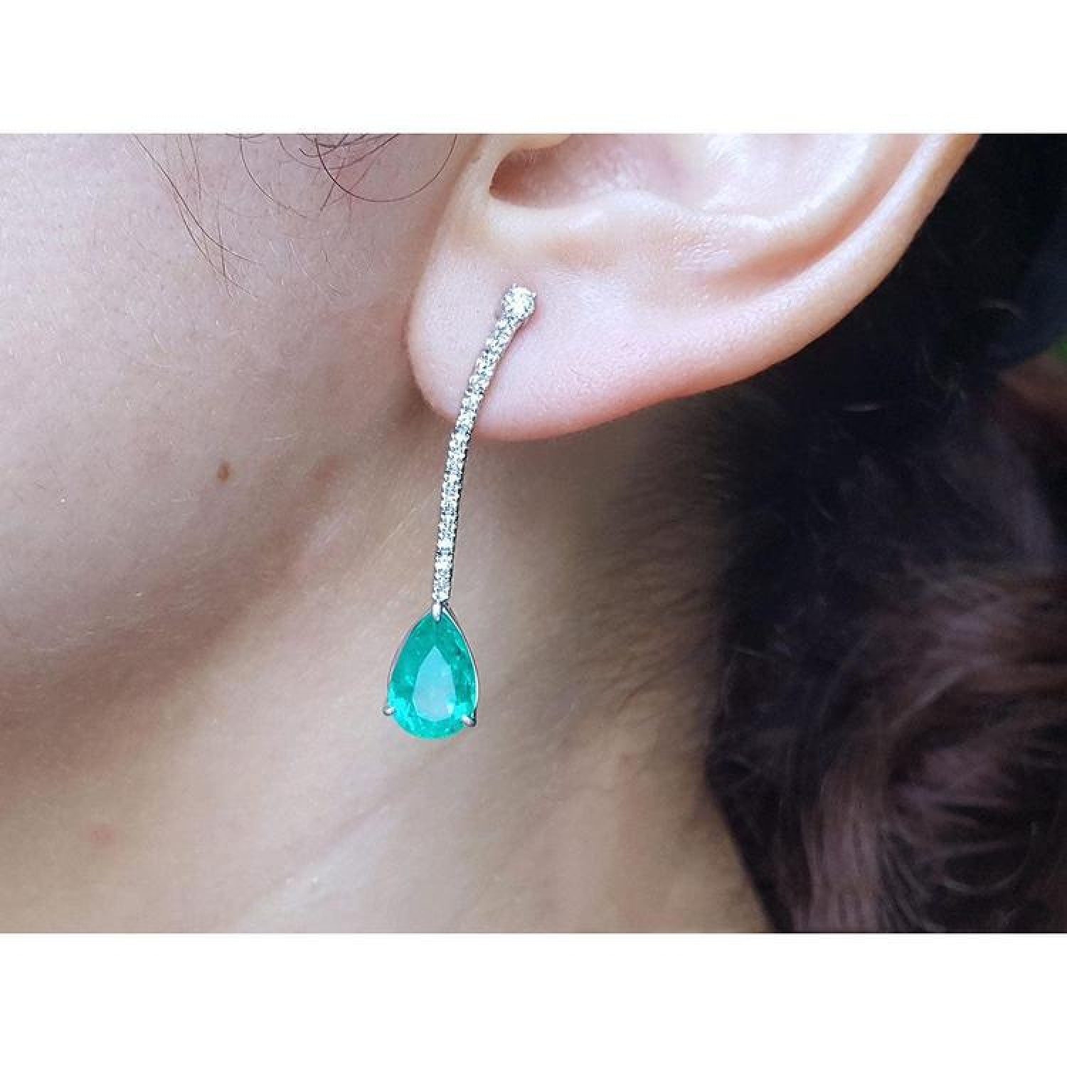 Pear shape 5.05 ct. Colombian emerald drop earrings in 18K white gold with diamond accents.