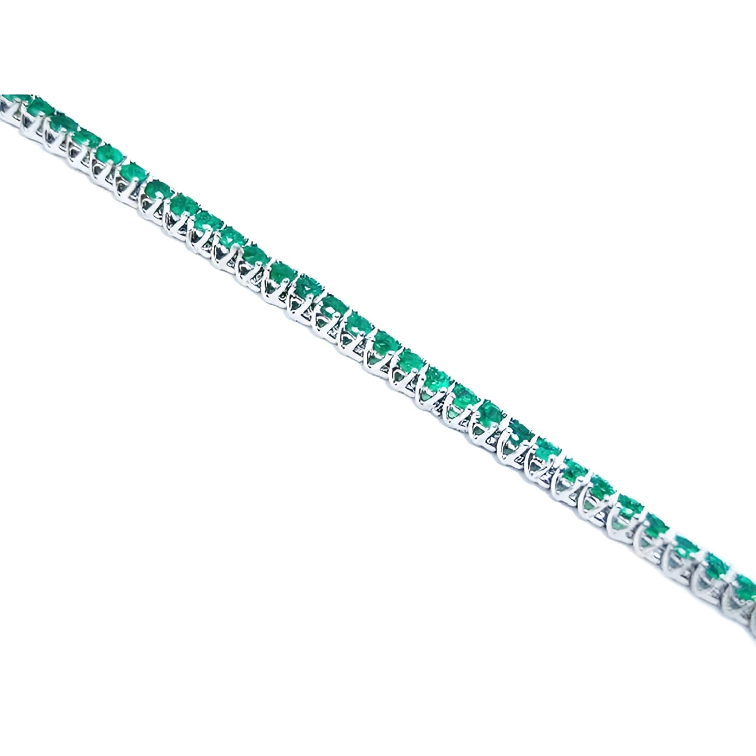 14K gold tennis bracelet with round-cut, medium deep green Colombian emeralds, prong set.