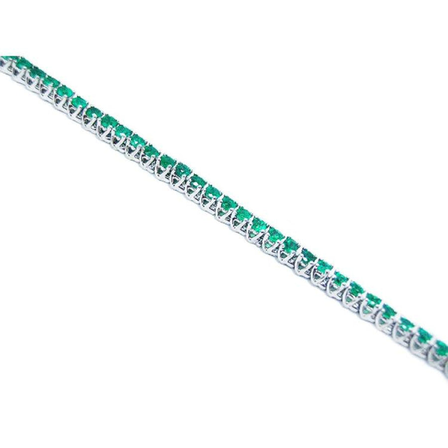 14K gold tennis bracelet with round-cut, medium deep green Colombian emeralds, prong set.