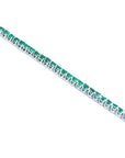 14K gold tennis bracelet with round-cut, medium deep green Colombian emeralds, prong set.