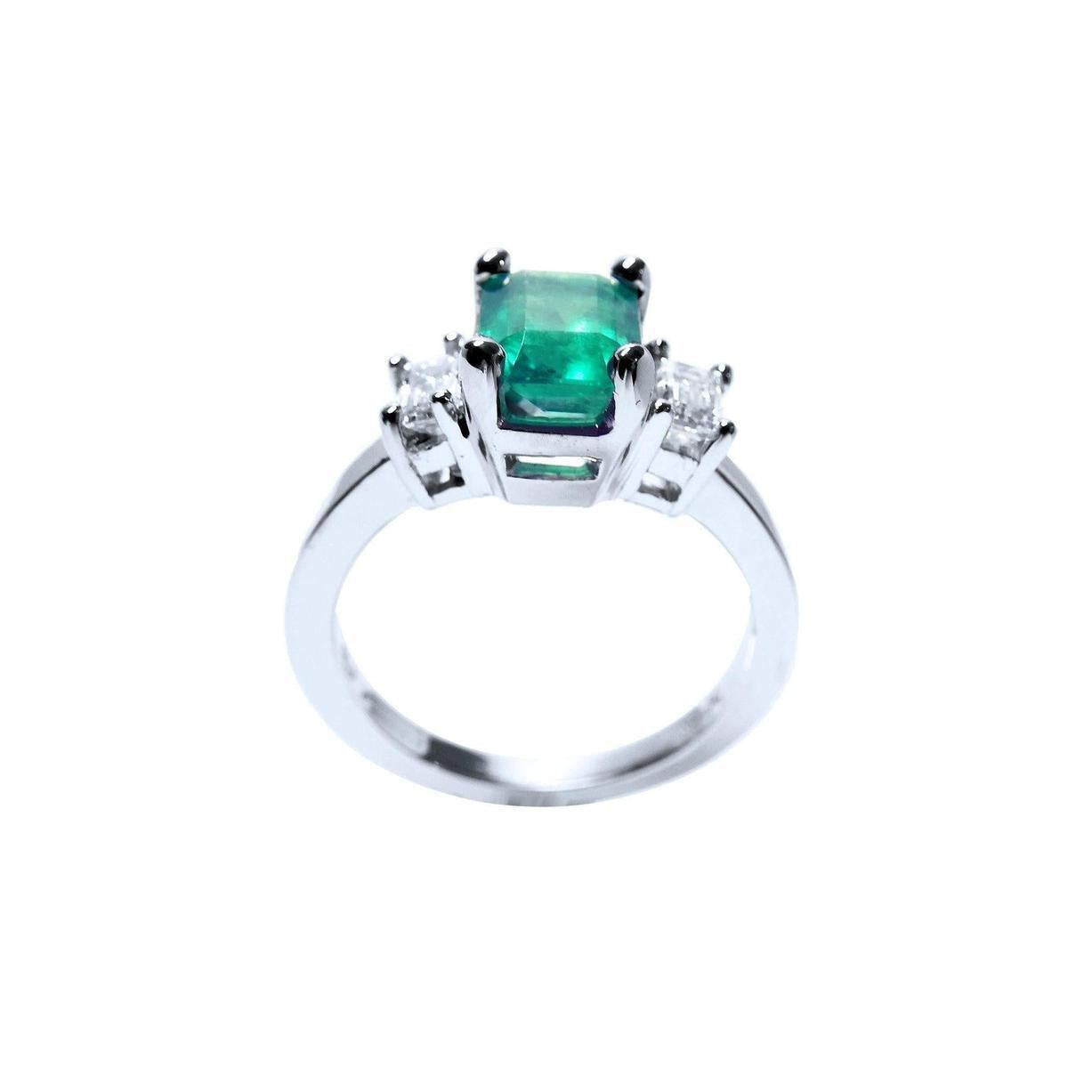 This natural emerald and side diamonds ring for women has a visible top and galley profile.