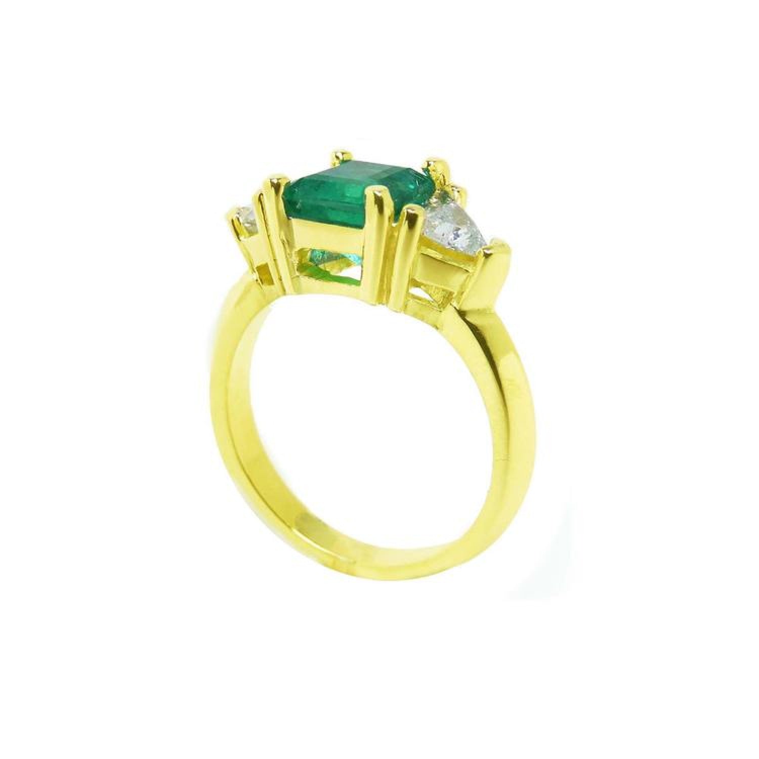 18K gold ring with a 1.48 ct emerald center stone and trillion side diamonds.