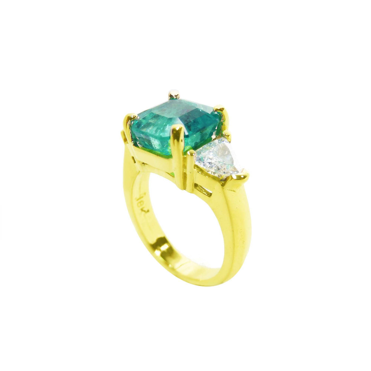 A half side profile of a yellow gold emerald and side trillion diamond ring.