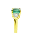 In a tilted position this emerald-cut emerald ring for women displays its side profile.