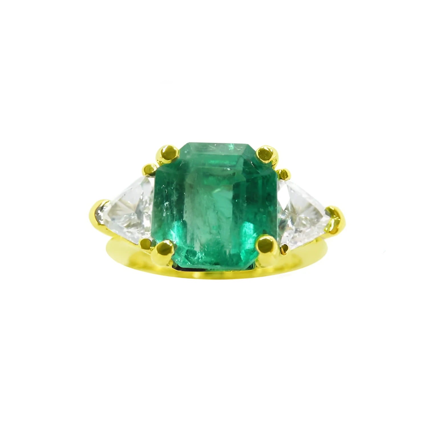 18k yellow gold ring with a rectangular green emerald and two trillion side diamonds.