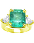 Emerald and trillion cut side diamond ring, front side position, top and side diamonds visibles.